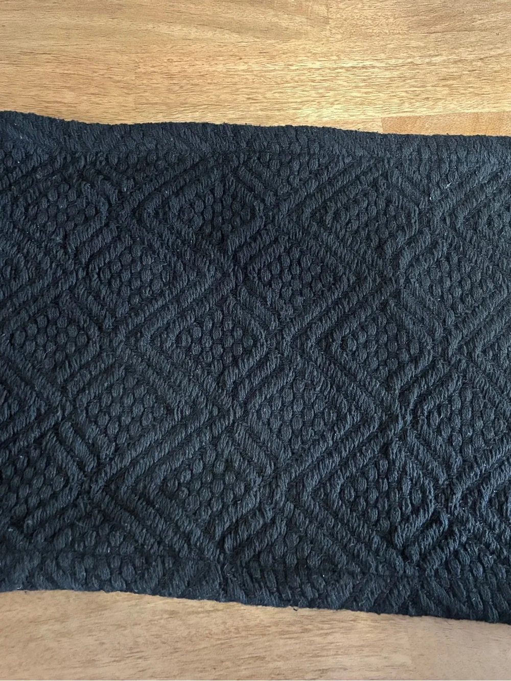 6 black placemats features a woven diamond pattern and decorative fringe edges
